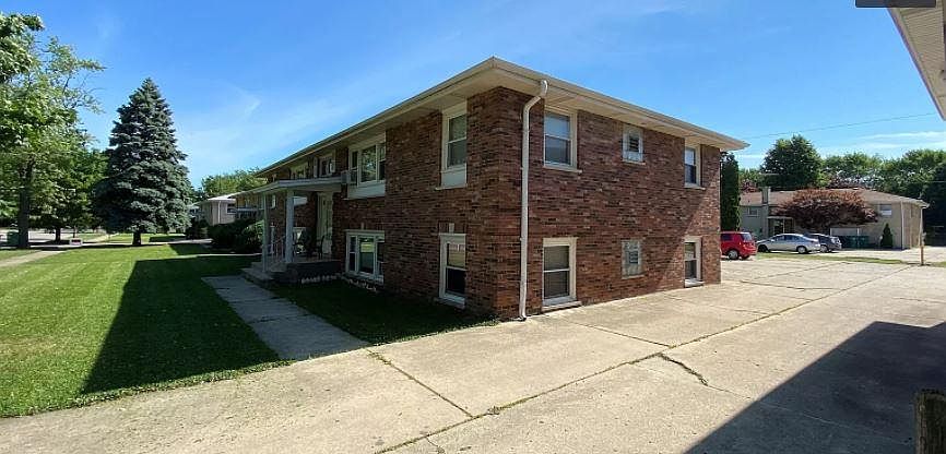 Front entrance of building with sideview of entrance to parking in the back of the building.