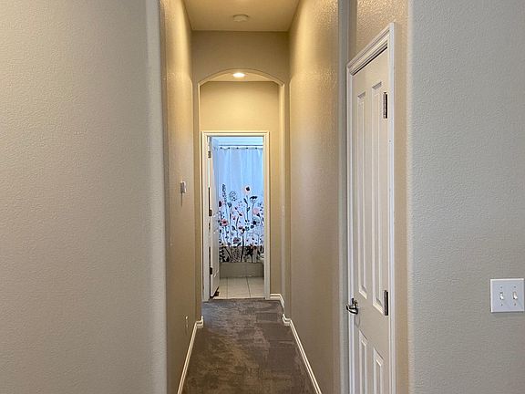 Arched entries and details. Hallway to full bath and second bedroom on the main floor.