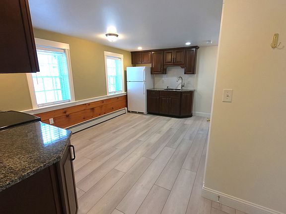 Renovated eat in kitchen with barnwood wainscoting.