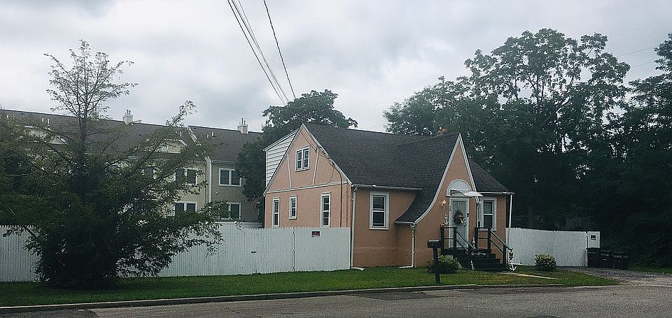 Front of house with 6’ fence