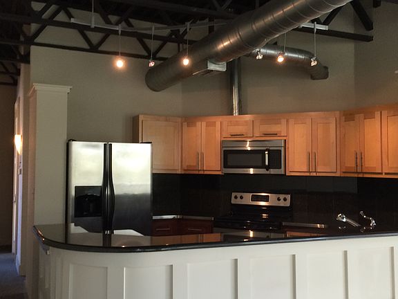 Loft apt, wrap around bar separates the kitchen and living. Vaulted ceilings.