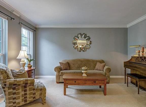 The smart looking living room is the perfect spot for piano lessons or relaxing with a good book.