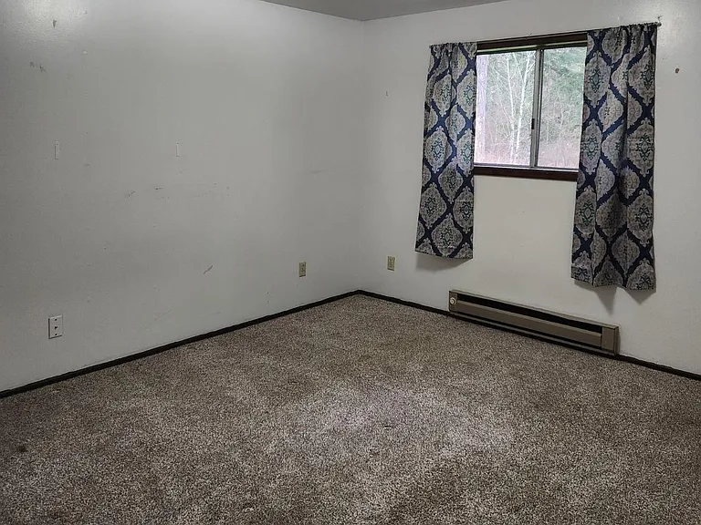 Bedroom with window facing river.