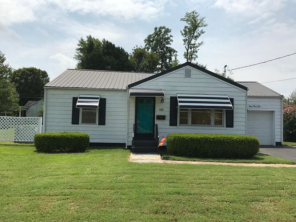Front of house, attached garage, new metal roof. Asphalt over concrete driveway for two vehicles.