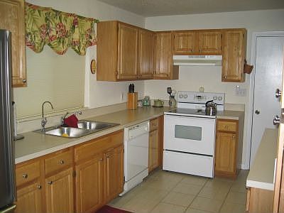 Kitchen sink has window and includes dishwasher, range and s/s refrigerator