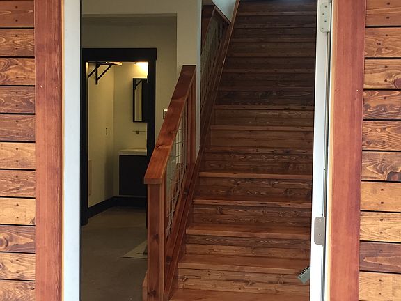 Entrance of the house flows into the downstairs living space, 2nd bedroom and bath, washer and dryer.