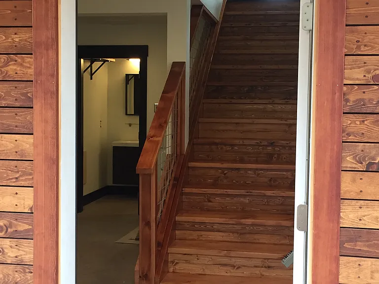 Entrance of the house flows into the downstairs living space, 2nd bedroom and bath, washer and dryer.