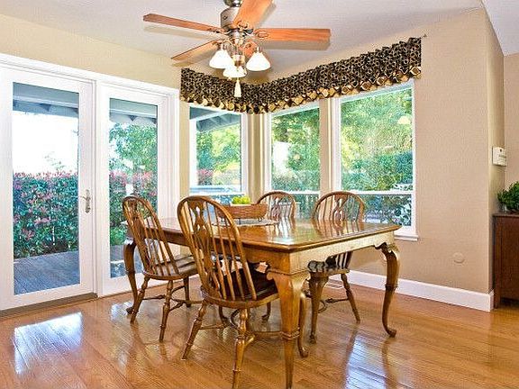 Spacious kitchen eating area with French doors leading to porch.