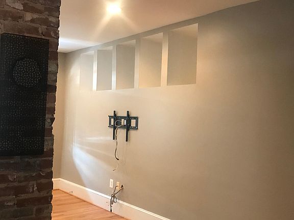 TV mount and cutouts in family room.