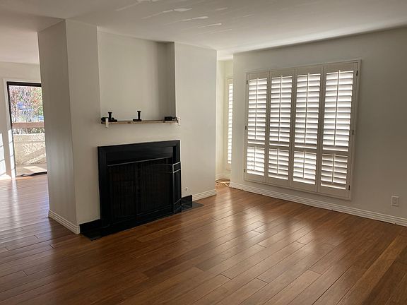 living room with plantation shutters and beautiful floors
