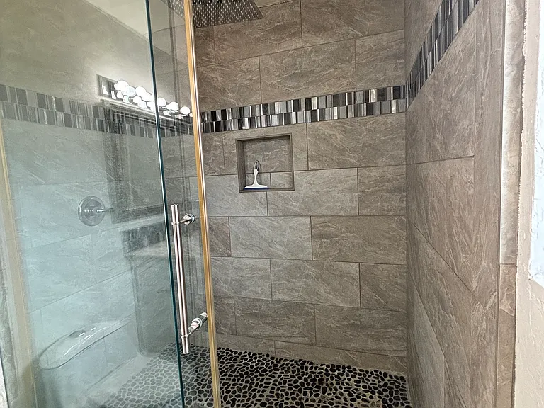 Primary bathroom, spacious tiled shower.