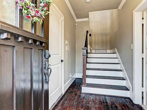 Ground floor foyer entrance. Garage is to the left and third bedroom with en-suite bath on the right.