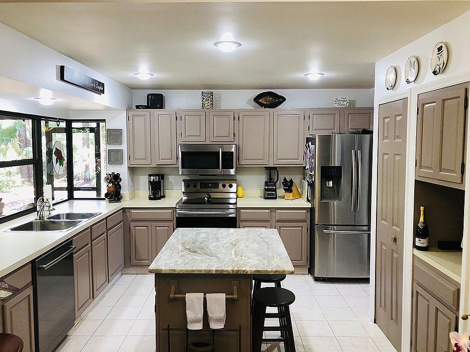 Taupe cabinets marble island