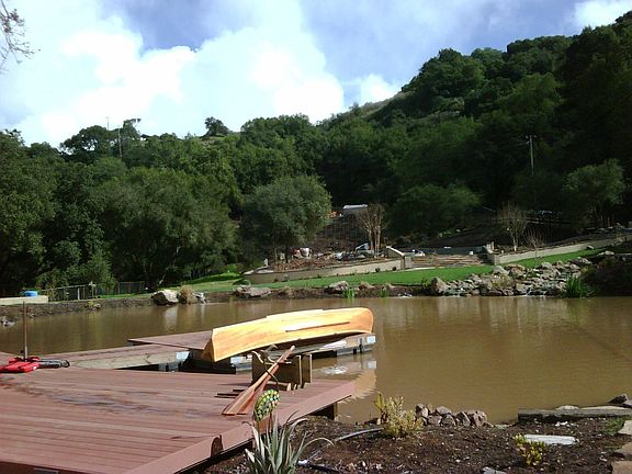 Looking SW across pond toward pool deck, garden and greenhouse