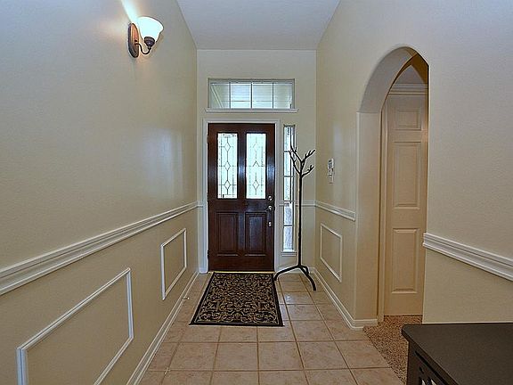 A tiled entry foyer leads past the entry to the secondary bedrooms.
