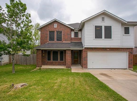Brick face on three sides, two car garage, and covered patio...