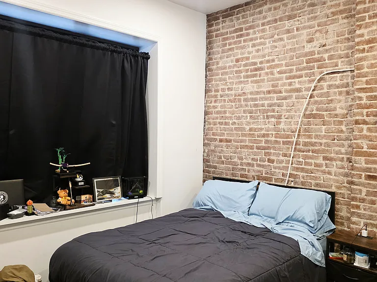 Large bedroom facing Washington with large closet and exposed brick