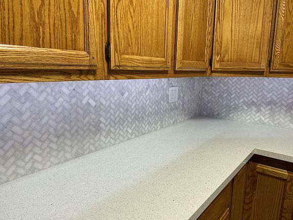 Beautiful stone counter tops and back splash in kitchen.