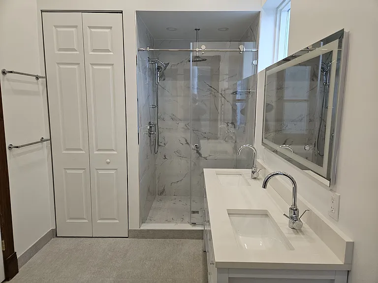 2nd floor suite: bathroom, shower, vanity, washer dryer closet.