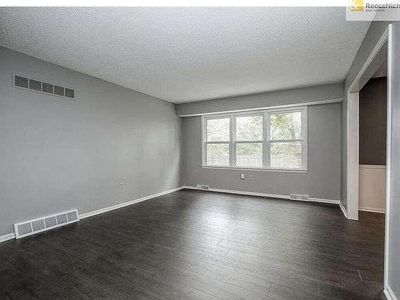 Living Room with Wall of Windows, New Flooring & Fresh Paint
