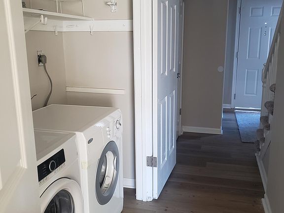 Backward look at front door with laundry closet open