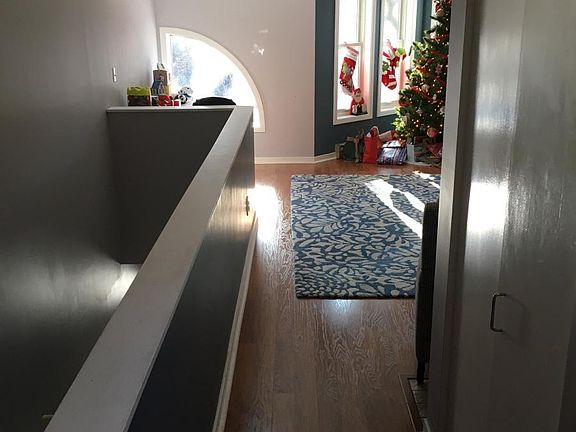 Family room and hallway and closet at the top of the stairs