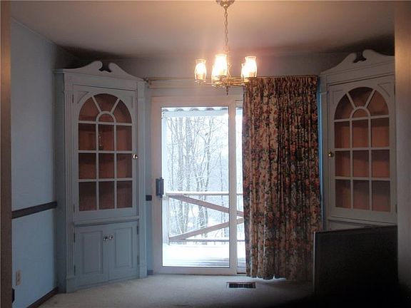 Dining room with Built in corner cupboards, slider to deck