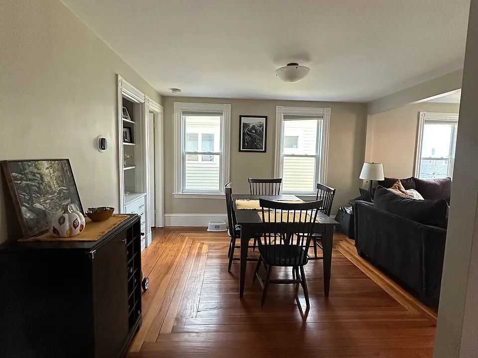 Open dining room from kitchen and living room. Built-in hutch on the left.