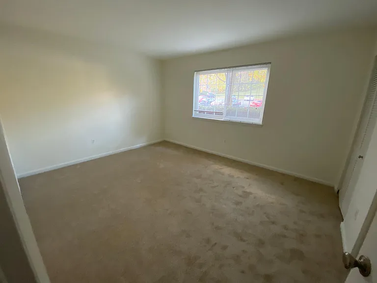 Bedroom carpeted with closet