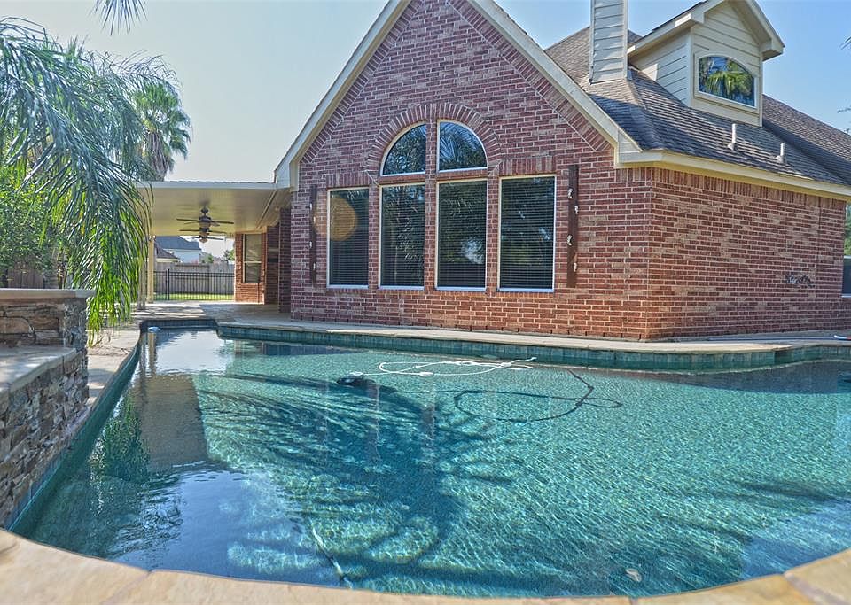 Great view of pool and house. Note the gated area in the far rear of photo