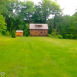 1a field across road with a cottage.