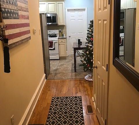 hall from living room to kitchen. bathroom on right. bedroom in back