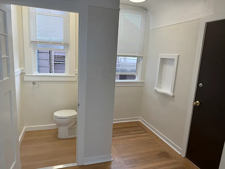 1/3 bathroom (just a toilet) + small entry nook. front door on the right