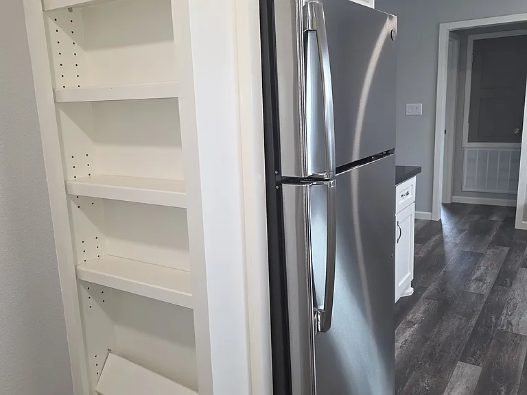 Building spice or can rack with door. missing hardware (waiting on hardware to hang door) Stainless steel with ice make refrigerator.