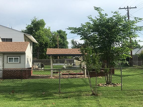 Nice back yard with covered patio and outdoor fire place
