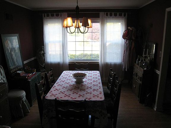 Dining room view looks out at driveway, yard area.