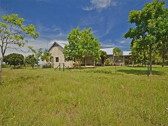 3100 W Fitzhugh is located on 5 private and secluded acres. One of the 2 fenced pastures is shown he
