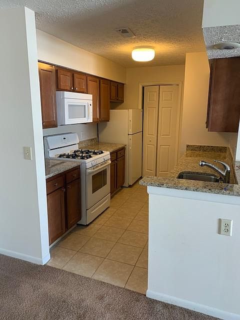 Galley style kitchen- microwave, dishwasher, refrigerator and gas range