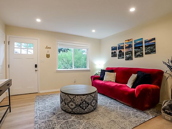 Living room with luxury vinyl flooring, tons of natural lighting and a front hall closet