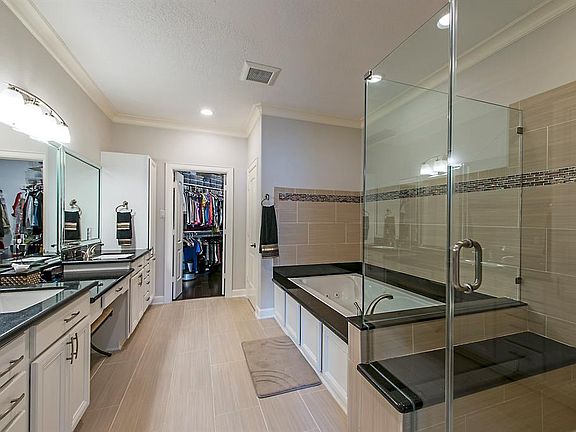 Great master bath with separate tub and frameless shower, dual sink vanity with dressing counter.