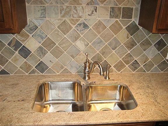granite counters, slate backsplash in kitchen