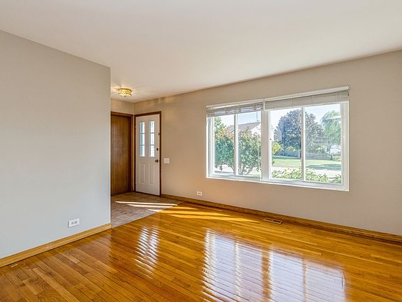 Hardwood floors in the Living Room with tons of light pouring in front windows!