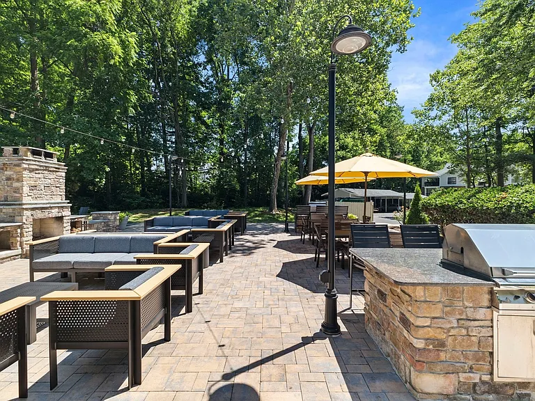 Outdoor entertainment area with fireplace and bbq stations