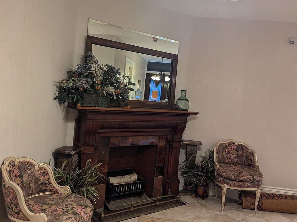Foyer with original decorative wood fireplace