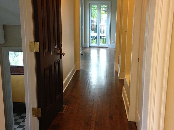 Hallway with display nooks/bookshelves and coat closet