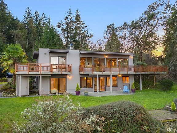 The north elevation shows the banks of windows that flood the home with light and views. Main floor suite on upper left has its own private balcony. Large deck on upper right is accessed from dining area and is generous and inviting.