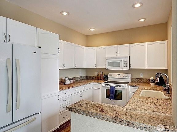 Updated kitchen with refrigerator, microwave and electric range