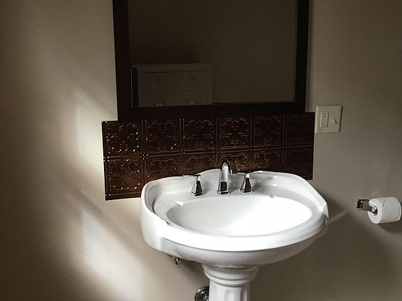 First floor bathroom with pedestal sink.