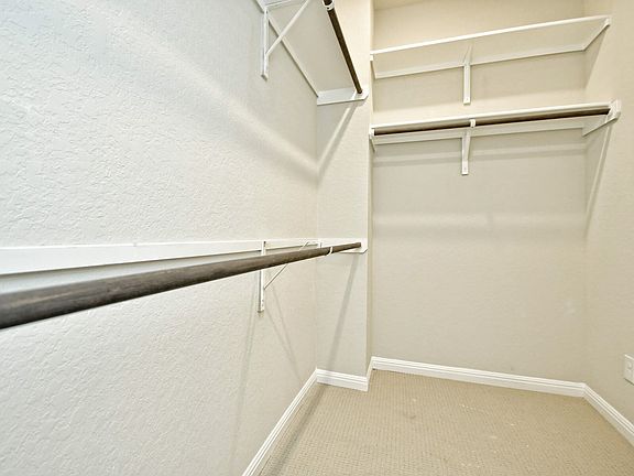 Primary suite walk-in closet in the San Saba floorplan at a Meritage Homes community.