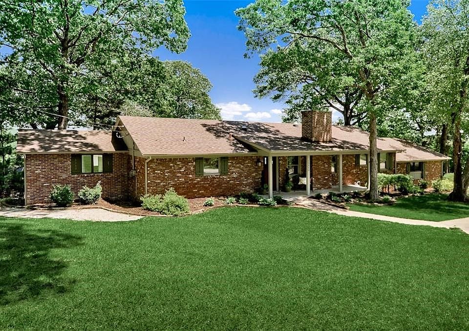 Nestled Among Gorgeous Trees, this Charming Brick Lake House with Enchanting Details is the Perfect Home Away from Home or Everyday Oasis!